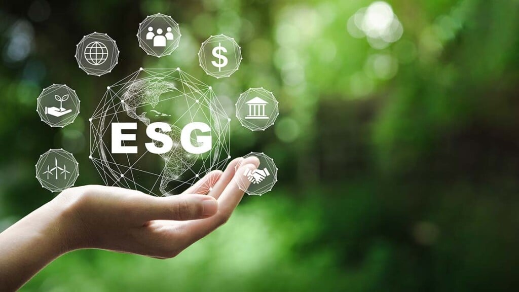The word ESG is depicted in a person's hand.
