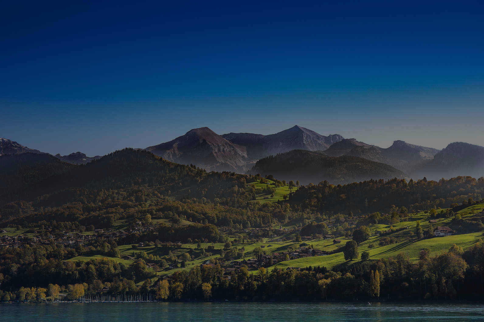 A lake with mountains in the background.